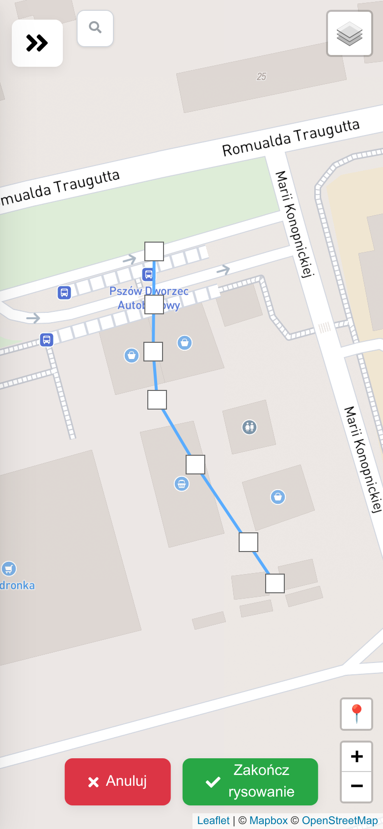 A line being drawn on the map from the bus station platforms through the passage between the kiosks towards the market square.
